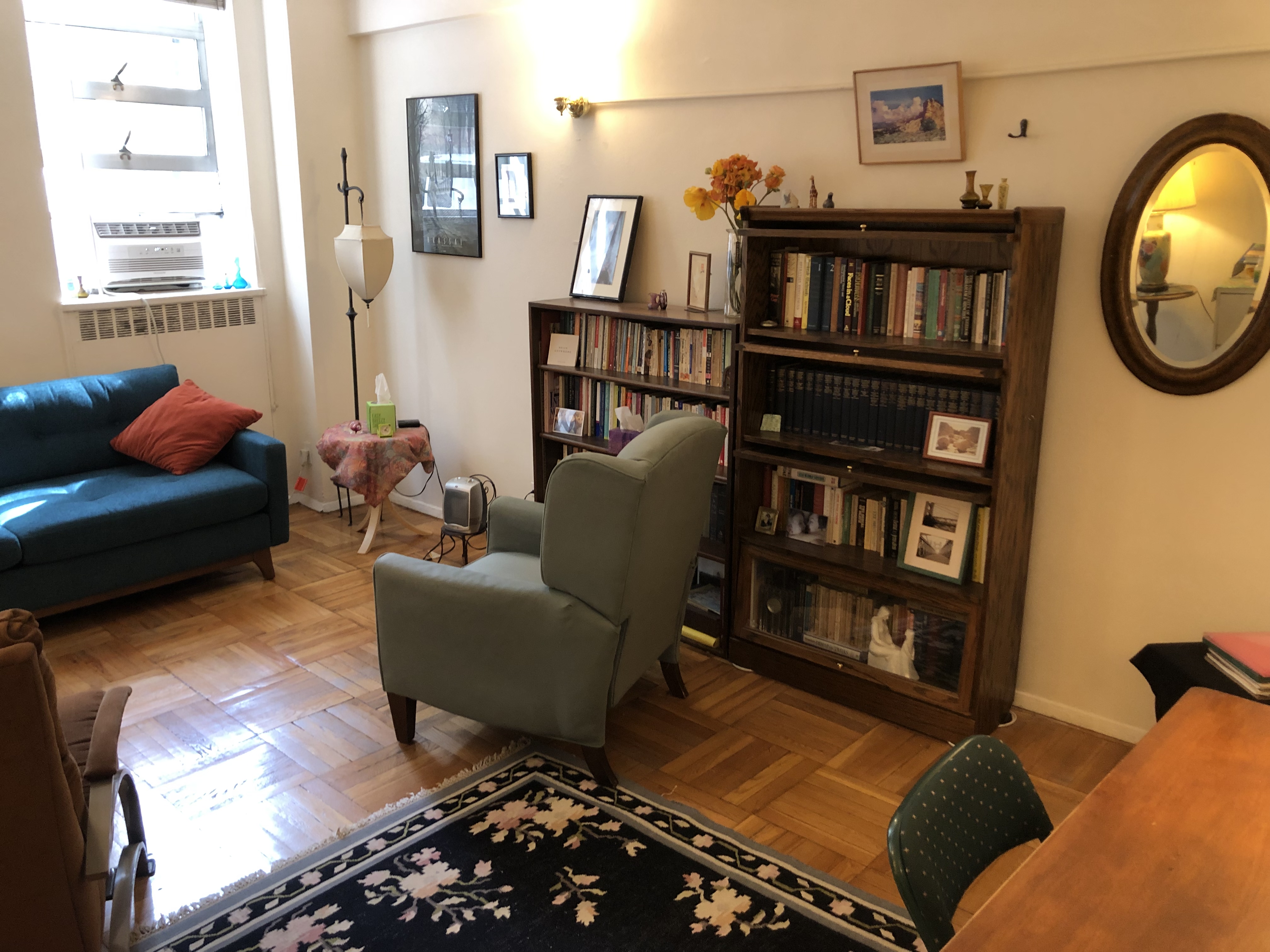 Comfortable therapy room with cozy seating, modern decor, and soft lighting.