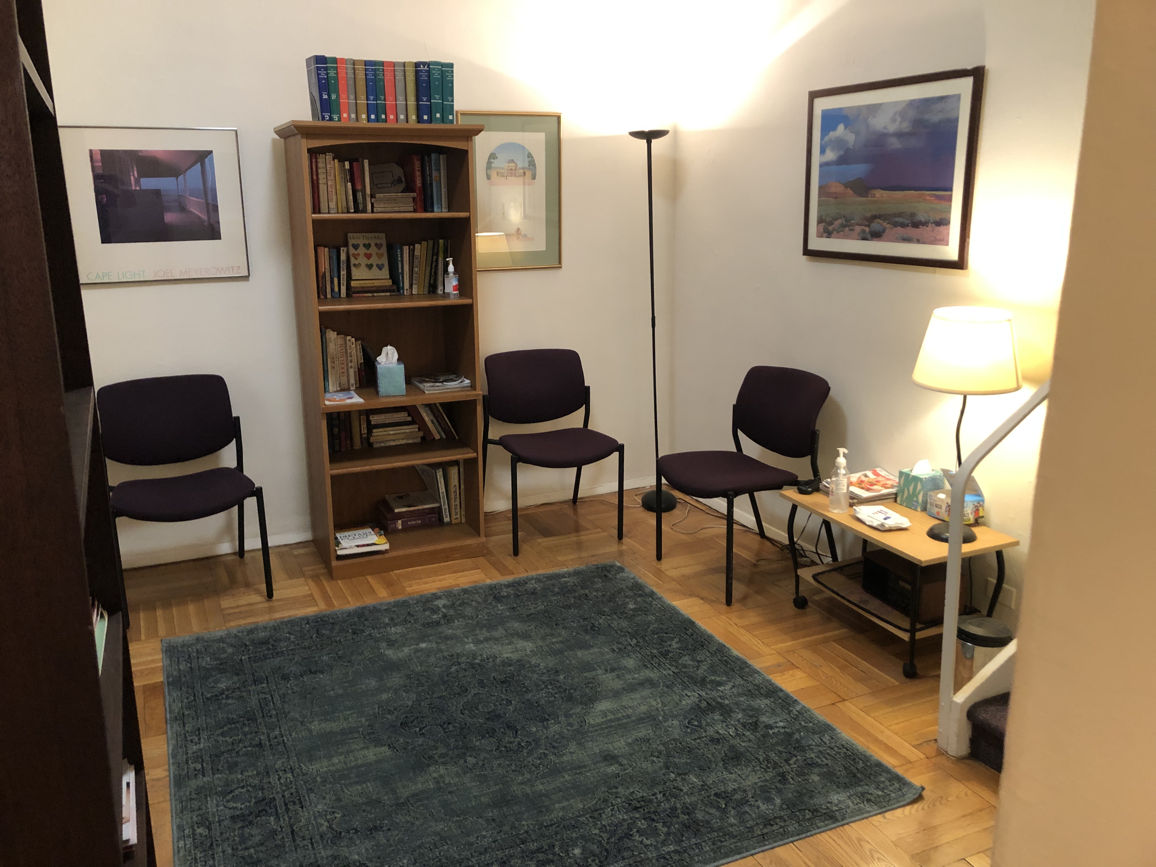 Comfortable therapy room with cozy seating, modern decor, and soft lighting.