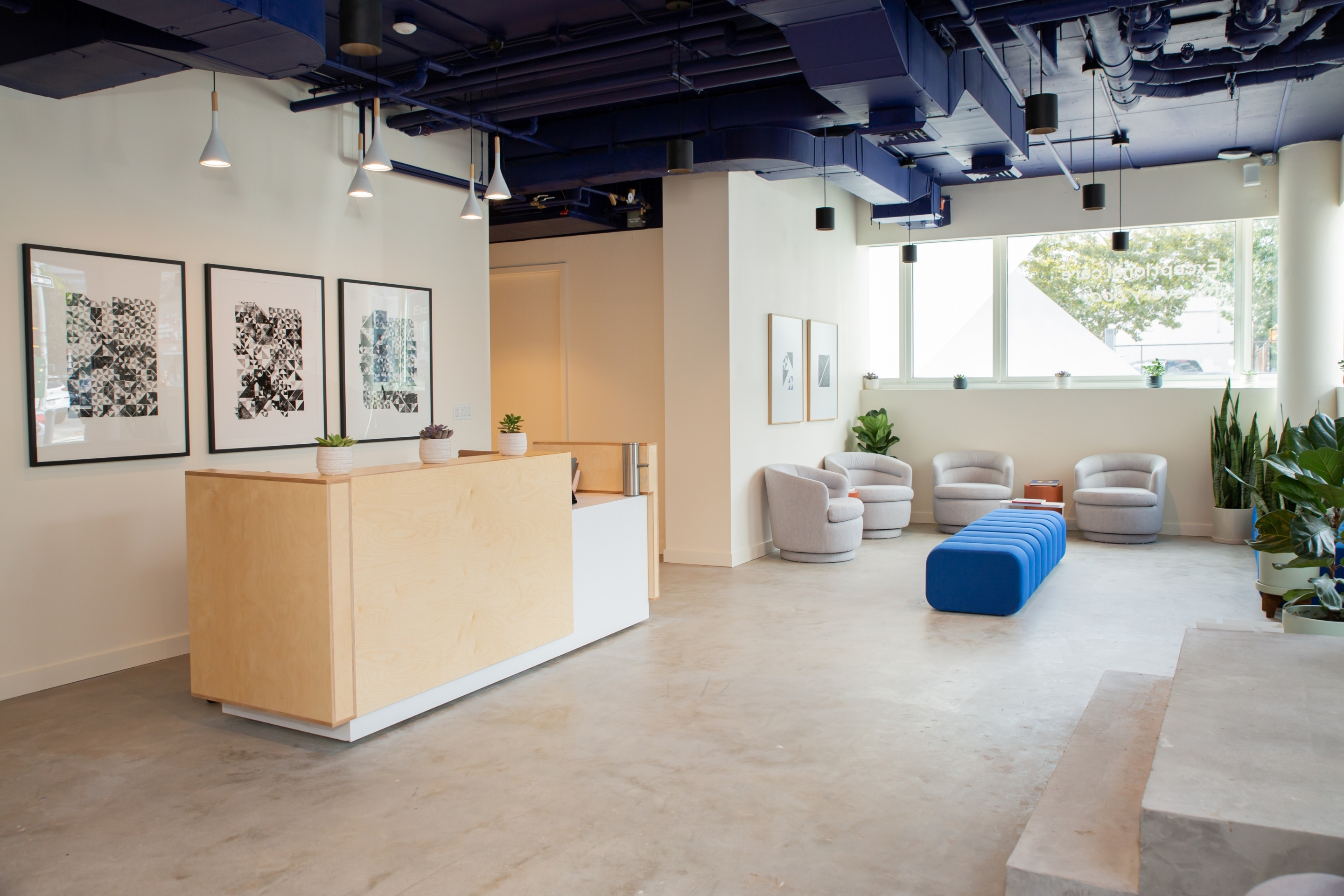 Modern hallway with stylish flooring and a chair